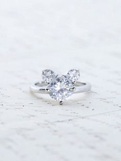 a white gold ring with two diamonds on it