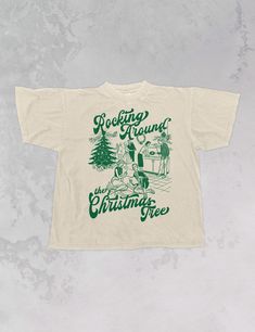 Start Rocking Around the Christmas Tree in our super cozy oversized tshirt, just in time for the Holiday season!- Features a Christmas party with the phrase "Rocking Around the Christmas Tree" around it all in a deep green ink- Screen print transfer that is individually heat pressed onto each tshirt- Printed on a vintage wash, super soft tshirt that gets softer with each wash- 100% Cotton- Oversized fit- Sizing translation: XS/S - L , S/M - XL , L/XL - 2XL , 2XL/3XL - 3XL**due to screens & filters color may vary from pictures** Retro Christmas Tshirt, Cool Christmas Shirts, Vintage Christmas Shirts, Sorority Christmas Shirts, Tshirt Trends 2024, Christmas Tshirt Ideas, Winter Shirt Design, Christmas Merch, Rocking Around The Christmas Tree