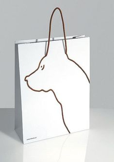 a white shopping bag with a dog's head drawn on it