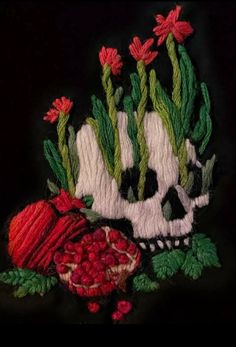 a skull with flowers and leaves on it