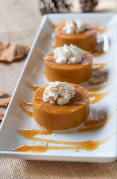 three small desserts on a white plate with caramel drizzle