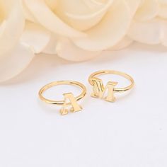 Personalize your style with these stunning 14k Gold Initial Rings. Each ring is crafted from solid 14k gold and features a bold initial, making it a perfect statement piece or a thoughtful gift. Whether you wear your own initial or that of a loved one, these rings add a unique and personal touch to any outfit. Details: Material: Solid 14k gold Design: Bold initial (A, M, and other available letters) Style: Elegant and customizable Ideal for everyday wear or special occasions, these initial rings are a timeless addition to any jewelry collection. Order yours today and celebrate your individuality with the lasting charm of 14k gold. Yellow Gold Initials Ring, Rose Gold 14k Gold Rings With Initials, Gold Sterling Silver Initial Stackable Ring, Gold Sterling Silver Stackable Initial Ring, 14k Rose Gold Initial Ring For Anniversary, Luxury 14k Gold Initial Ring For Anniversary, 14k Gold Ring With Initials Jewelry, Fine Jewelry 14k Gold Rings With Initials, Luxury 14k Gold Anniversary Initial Ring