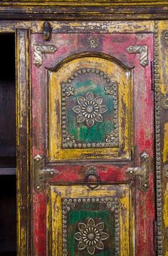 an old wooden cabinet painted with different colors