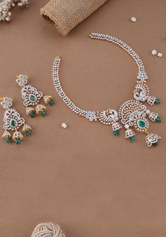 Introducing the stunning Twin Dancing Peacock Victorian Necklace Set, meticulously crafted with white stones accentuating the intricate floral design. The centerpiece features a captivating green stone, surrounded by delicate floral motifs and leaf vines. Completing the ensemble are elegant dangling jhumkas adorned with green beads, exuding timeless elegance and charm. 925 silver and adorned with sparkling semi-precious Zirconia to ensure the best dazzling jewelry ever. The zirconia stones add a Elegant Round Necklace With Peacock Design, Elegant Round Peacock Design Necklace, Green Peacock Design Necklace As A Gift, Traditional Green Bridal Necklace With Diamond Accents, Traditional Diamond Jewelry With Peacock Design, Traditional Green Diamond Necklace, Traditional Diamond Necklace With Peacock Design, Green Cubic Zirconia Jewelry With Stone Work, Green Stone Work Bridal Necklace