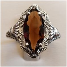 Gorgeous Cocoa Colored Smokey Topaz Has Beautiful Sparkles Of Golden Rays... Set In 925 Stamped Sterling Silver. Please See All Pictures For More Detail And Measurementsml. Brand New. Never Worn. Wholesale Prices Always....Or Less Elegant Hallmarked Topaz Ring, Formal Silver Topaz Ring With Gemstone, Classic Marquise Jewelry With Intricate Design, Ornate Silver Jewelry With Accent Stones, Classic Formal Topaz Jewelry, Formal Brown Hallmarked Jewelry, Vintage Silver Topaz Ring With Diamond Cut, Vintage Sterling Silver Marquise Jewelry, Antique Silver Marquise Jewelry