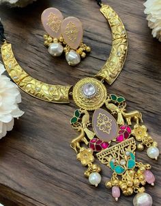 Sabyasachi Inspired Polki Hasli Necklace, featuring a long Kundan pendant in gold-plated fusion. Ideal for blending traditional and contemporary vibes, pair it with a modern saree or fusion outfit. Keep your makeup dewy and your hairstyle sleek to ensure the necklace remains the statement piece. *𝐏𝐑𝐎𝐃𝐔𝐂𝐓 𝐃𝐄𝐓𝐀𝐈𝐋* * Material: Brass * Plating: Gold Plated. * Stone: Semi Precious Carved Stones, Kundan, Polki *𝐃𝐈𝐒𝐂𝐋𝐀𝐈𝐌𝐄𝐑* Product color may slightly vary due to photographic ligh Gold Kundan Chandbali Necklace, Gold Kundan Necklace With Latkans, Gold Chandbali Necklace With Latkans, Gold Kundan Bridal Long Necklace, Gold Long Kundan Necklace For Festive Occasions, Festive Gold Long Kundan Necklace, Heavy Gold Kundan Long Necklace, Gold Chandbali Bollywood Necklace, Gold Meenakari Necklace Bollywood Style