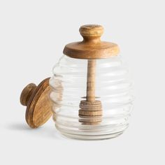 a glass jar with a wooden top and lid