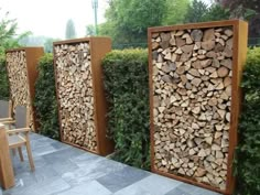 three wooden panels are lined up next to each other on the ground with chairs and tables in front of them