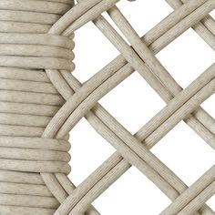 a close up view of the side of a white wicker chair with braiding