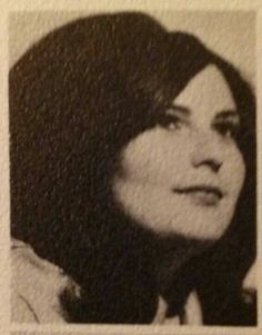 an old black and white photo of a woman's face with long dark hair