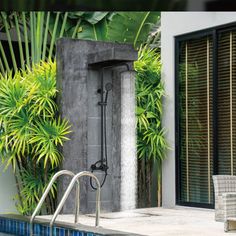 an outdoor shower next to a swimming pool