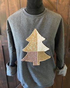 a gray sweater with a christmas tree on it