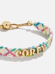 Our Criss Cross Custom Woven Friendship Bracelet offers an updated take on the ever-loved friendship bracelet trend. Colorful woven thread creates a criss cross patterned backdrop for graphic gold letter beads. Each letter is sewn on by hand for this bracelet. Pick up one for you and a friend, then choose to add your name, initials, or a favorite phrase. See our Letter Key for all options available. Please note: due to their handmade nature, each bracelet will be slightly unique. Custom Gifts For Friends, 2024 Christmas Gift Trends, Valentines Gifts For Students, Grad Gifts For Best Friends, Cute Birthday Gifts For Best Friend, Adult Friendship Bracelets, Pickleball Bracelet, Bauble Bar Bracelet, Gifts For High School Seniors