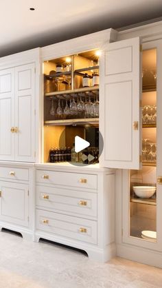 a kitchen with white cabinets and gold trim