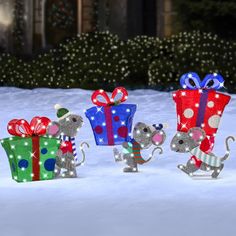 three little mice are holding presents in the snow