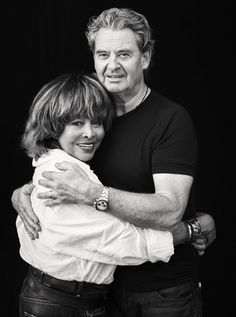 black and white photograph of two people hugging each other with their arms around one another