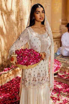 Ivory kurta featuring mirror, sequin, bead, and thread embellishments in geometric and floral patterns. Paired with a flared skirt and an ombre dupatta with border embellishments., Fit: Relaxed White Salwar Kameez With Pearl Embroidery, Traditional Off White Sharara With Pearl Embroidery, Off White Traditional Sharara With Pearl Embroidery, Bollywood Off White Dress With Mirror Work, Elegant White Embellished Salwar Kameez, Elegant White Sequined Sets, Elegant White Sets With Sequins, Designer White Salwar Kameez With Pearl Embroidery, White Embellished Semi-stitched Salwar Kameez