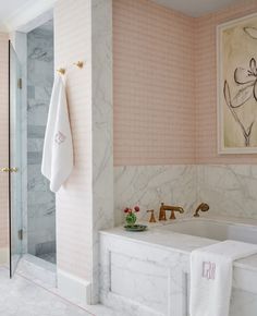 a bathroom with pink walls and marble floors