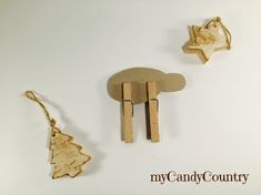 two wooden ornaments are hanging from clothes pins on a white background with the words my candy country written below them