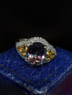 Here we have a stunning cocktail ring featuring sparkling natural multi gemstones including a central mystic topaz with citrines and diamond set in 9ct yellow gold.  UK size - P US size - 7.75 Message me any questions  ITEM - S1928 Multicolor Oval Amethyst Gemstone Ring, Multicolor Oval Amethyst Ring With Gemstone Accents, Multicolor Oval Amethyst Ring With Accent Stones, Multicolor Oval Amethyst Ring, Oval Multicolor Hallmarked Ring, Multicolor Oval Hallmarked Ring, Multicolor Amethyst Ring Fine Jewelry, Multicolor Oval Halo Setting Jewelry, Oval Multicolor Jewelry With Halo Setting