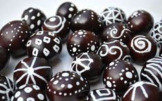 some chocolate eggs with white designs on them