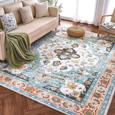 a living room filled with furniture and a large rug