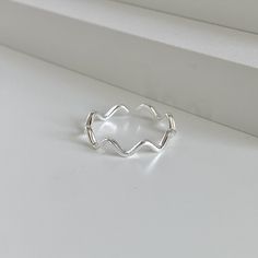 "Immerse yourself in the elegance of the sea with the Minimalist Dainty Sterling Silver Wave Ring. Delicately crafted from 925 Sterling Silver, this unique ring captures the essence of the timeless dance of the ocean waves in the form of a wave ring. Each wave is intricately designed, flowing seamlessly into the next, creating a harmonious circle that encases your finger with grace. This statement ring is more than just an accessory; it's a wearable piece of art. Its dainty ring design, reminisc Silver Wave Ring, Mini Rings, Simple Silver Ring, Best Friend Rings, Friend Rings, Silver Rings Simple, Fancy Rings, Wave Ring, Statement Ring Silver