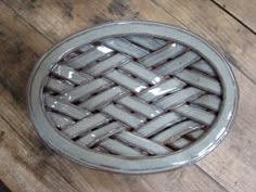 a small gray basket sitting on top of a wooden table