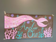 a sign that says, andia is one with an image of a mermaid on it