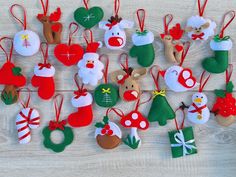 a collection of felt christmas ornaments on a table