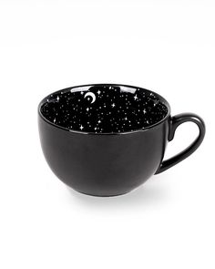 a black cup with stars and moon designs on it