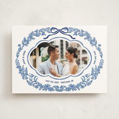 a blue and white photo frame with an image of a man and woman in the center