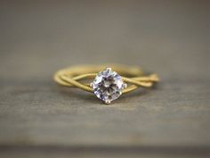 a close up of a ring with a diamond on it