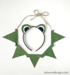 an ornament shaped like a frog hanging from a string