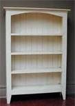 a white bookcase sitting on top of a hard wood floor