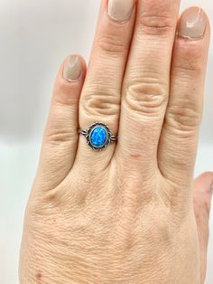 "Welcome to Darling Grace! This ring is a gorgeous blue opal ring. The blue color on this ring is so mesmerizing.  Size: 7 Metal Purity: 925 Sterling Silver Stone: Blue Opal Free Shipping!  Comes packaged in a ring box ready to gift! Consider upgrading your box to black leather and purchasing a cleaning cloth during check out.  You can take a peek of these options in the \"Essentials\" section.  Thank you!" Blue Opal Promise Ring, Blue Opal Birthstone Ring In Sterling Silver, Adjustable Blue Opal Ring, Blue Opal Round Ring, Blue Round Opal Ring, Blue Sterling Silver Opal Promise Ring, Blue Opal Open Ring With Gemstone, Blue Opal Open Ring, Adjustable Blue Opal Gemstone Ring