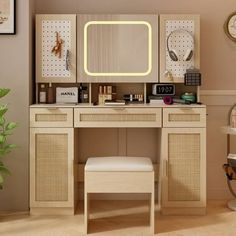 a desk with a mirror, stool and clock on it in a room that has beige walls