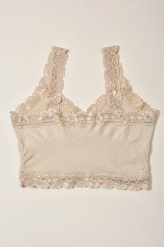 A lightweight cami with lace trim detailing Brand: M. Rena Fabric Content: 92% Nylon | 8% Spandex Size + Fit: One size Stretch Sleeveless Camisole With Delicate Lace, Lace Cami Tank Top With Lace Trim, Seamless Lace Tank Top With Spaghetti Straps, Beige Fitted Lace Tank Top, Stretch Lace Trim Camisole With Spaghetti Straps, Stretch Camisole With Lace Trim And Spaghetti Straps, Feminine Beige Lace Trim Tank Top, Beige Lace Camisole With Built-in Bra, Feminine Stretch Lace Trim Camisole