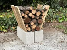 a stack of logs sitting on top of cement blocks