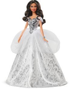 PRICES MAY VARY. 2021 Holiday Barbie doll reflects the magic of the season in a gorgeous gown, sparkling with sophisticated glamour. Her elegant floor-length dress features off-the-shoulder ruched sleeves and a metallic bodice with dazzling sculpted "gemstones." Accented with a tulle peplum and silvery accents, her full skirt sparkles from every angle. Silvery "pearl" earrings, sparkling eye makeup and bold red lips complete her dazzling look. Barbie doll's long, brunette hair is styled in gloss Sparkle Eye Makeup, Barbie Christmas, Barbie Signature, Silver Gown, Sparkle Skirt, Barbie Gowns, Bold Red Lips, Holiday Barbie, Barbie Toys