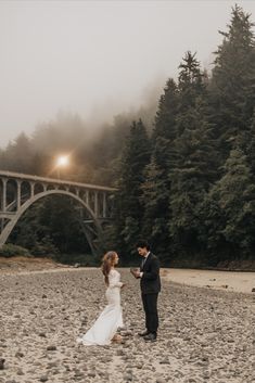 A couple in a wedding dress and suit exchange vows in front of a brridge on a beach in Oregon. Lighthouse Elopement, Oregon Coast Wedding, Oregon Coast Elopement, Couple Beach Pictures, Coast Elopement, Oregon Elopement, Wedding Photography Styles, Reception Details, Photography Styles