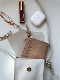 Artfully organize your belongings with THE CÆP's Mate Mini Crossbody. We believe the Mini Mate is the perfect accessory for basically any activity! Crafted with vegan leather, this chic accessory features an adjustable strap (19" min. drop, 23" max. drop), a main compartment that fits all phones with slim cases plus other essentials, an interior back pocket for cards and receipts. Plus, it has a ring for extra clip-on options, magnetic closure, and light gold hardware. Measurements of the Bag: W Chic Card Holder With Card Slots, Chic Card Holder For Everyday Use, Chic Rectangular Card Holder For Everyday Use, Trendy Phone Bag With Removable Pouch, Trendy Phone Bag With Removable Pouch For Everyday, Trendy Travel Wallet Rectangular, Trendy Travel Wallets Rectangular, Trendy Travel Wallets Rectangular Shape, Trendy Pouch With Removable Pouch For Daily Use