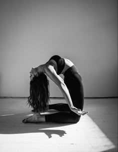 a woman is doing yoga on the floor