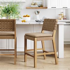 two wooden chairs sitting next to each other in a kitchen