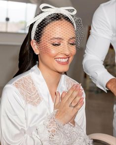 a woman wearing a veil and holding her hands together