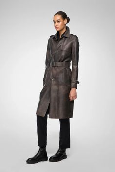 Women's Belted Leather Coat In Coffee Brown Step into sophistication with our women's belted leather coat in coffee brown. Made from genuine sheepskin leather with a semi-aniline finish, this coat combines luxury and durability. It features a stylish belted waist, turn-down collar, and button closure for a timeless look. Open hem cuffs with straps add a unique touch. Practicality is ensured with one inside pocket and two side pockets. This coffee-brown leather coat is the perfect blend of elegan Coffee Brown Color, Leather Shorts Women, Short Leather Skirts, Brown Leather Coat, Leather Coat Womens, Leather Jumpsuit, Shearling Vest, Studded Jacket, Distressed Jacket