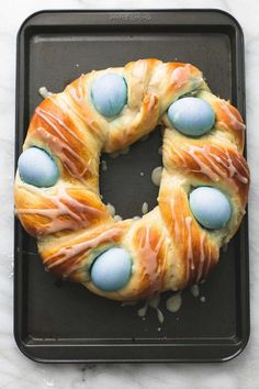 a cake with blue eggs in it sitting on a pan