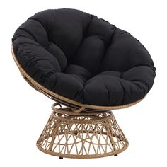 a rattan chair with a black cushion