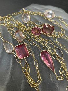 The necklace has 12 gorgeous natural tourmalines of multiple shapes and hues from dusty pink, peach pink to white, and ligth pink. The tourmalines are bezeled in solid 14K yellow gold on a beautiful textured oval link chain. They are ranging from size 1 carat to 3 carats each, and 10mm at the wides. The gold links are 5x3mm Lobster clasp marked 14K I designed and made this item in my shop, and take custom requests! Please feel free to reach out with inquiries! Fine Jewelry Pink Multi-stone Necklace, Pink Morganite Jewelry With Gemstone Accents, Pink Tourmaline Jewelry With Gemstone Accents, Pink Faceted Tourmaline Jewelry, Pink Morganite Gemstone Necklace, Ligth Pink, Natural Gemstone Jewelry, Long Beaded Necklace, Tourmaline Gemstone