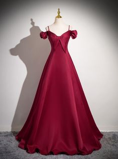 Otherworldly in its design, this maroon prom dress is crafted for those who wish to make a grand entrance. The dress features a unique off-the-shoulder neckline with delicate straps that add a touch of romance to the overall look. The bodice is expertly tailored to provide a flattering fit, with pleats that enhance the natural curves of the body. The skirt flows elegantly to the floor, made from a luxurious fabric that glides effortlessly with every movement. This gown is perfect for formal occasions where you want to exude confidence and elegance. The rich maroon color is both timeless and trendy, making it a versatile addition to any wardrobe. Pair it with simple accessories and let the dress be the focal point of your ensemble, ensuring you leave a lasting impression on all who see you. Burgundy Dress Formal, Ivory Formal Dress, Red Long Prom Dress, Fashion Formal Dresses, Off Shoulder Party Dress, Satin Long Prom Dress, Burgundy Prom, Tulle Party Dress, Dress Wine